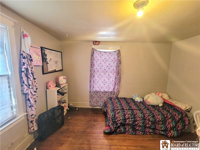 bedroom featuring wood-type flooring and baseboards