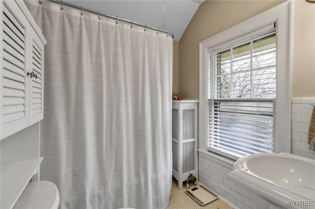 full bath featuring lofted ceiling and toilet