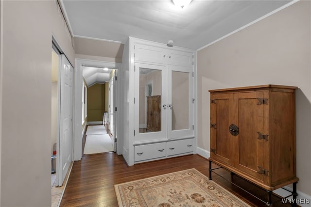 hall with ornamental molding, baseboards, and wood finished floors