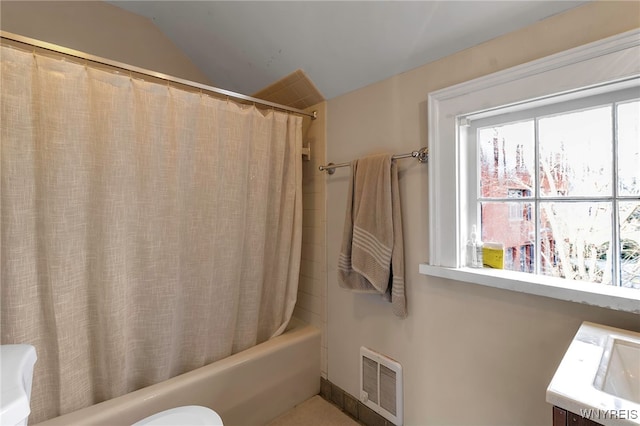 bathroom featuring shower / bath combo, visible vents, and lofted ceiling