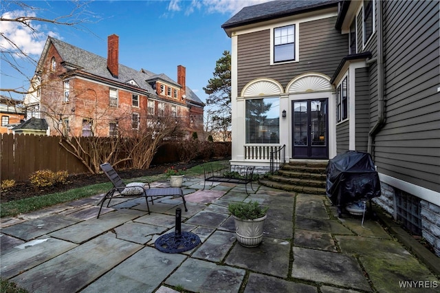 view of patio featuring french doors, fence, and grilling area