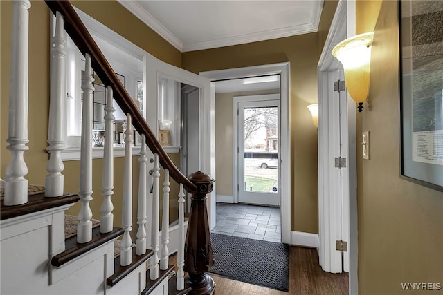 entrance foyer with stone finish floor, stairway, baseboards, and ornamental molding