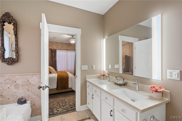 bathroom with double vanity, a sink, connected bathroom, and tile patterned floors