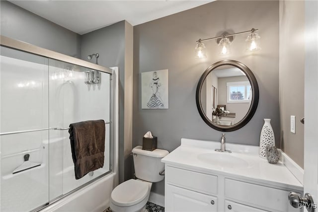 full bathroom with combined bath / shower with glass door, vanity, and toilet