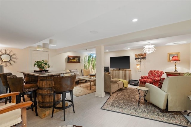 living area with light wood-type flooring and recessed lighting