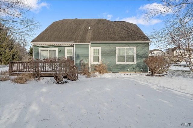 snow covered property featuring a wooden deck