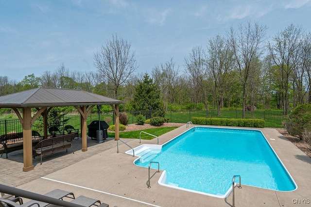 view of swimming pool featuring a patio area, a fenced backyard, a fenced in pool, and a gazebo