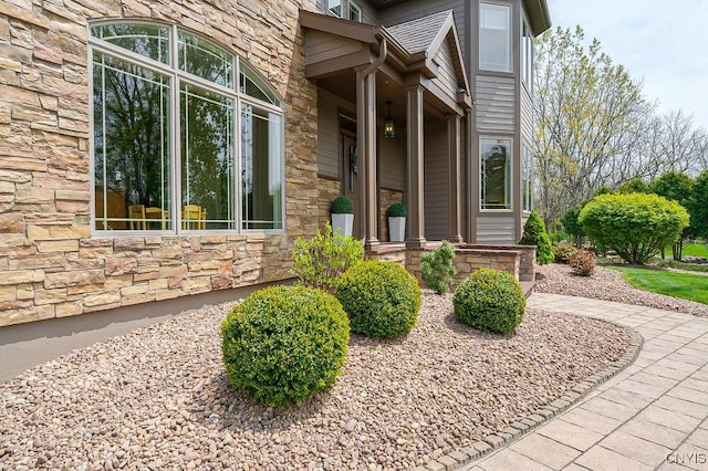 property entrance with stone siding