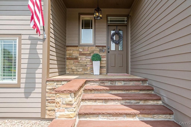 view of exterior entry featuring stone siding