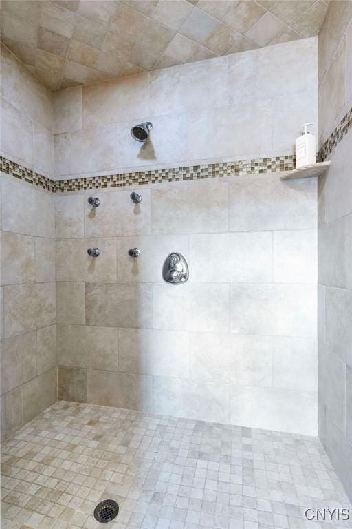 full bath with a tile shower