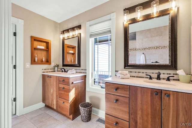 full bath with two vanities, tile patterned flooring, a sink, and visible vents