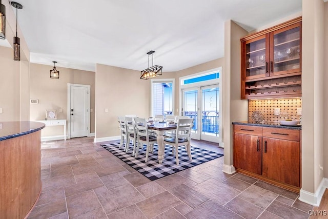 dining area featuring stone finish floor and baseboards