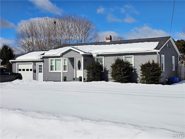 single story home featuring a chimney and an attached garage