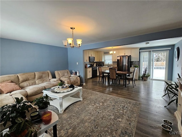 living area with a chandelier and dark wood-style floors