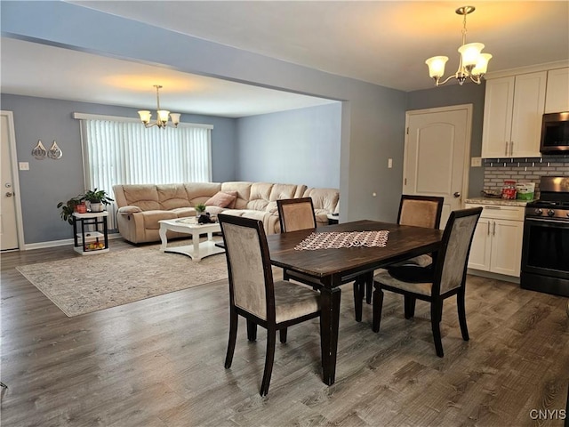 dining room with baseboards, dark wood-style flooring, and a notable chandelier