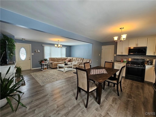 dining space with dark wood-style flooring, baseboards, and an inviting chandelier