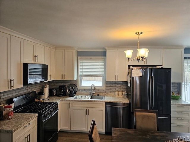 kitchen with dishwashing machine, a sink, black gas stove, white cabinetry, and freestanding refrigerator