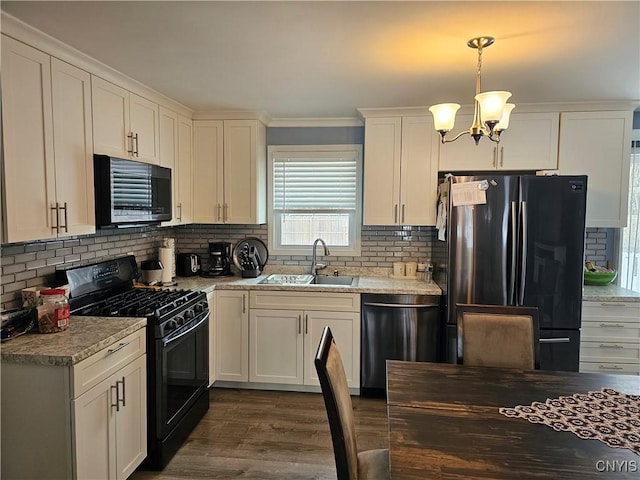 kitchen with black appliances, a sink, white cabinetry, and decorative backsplash