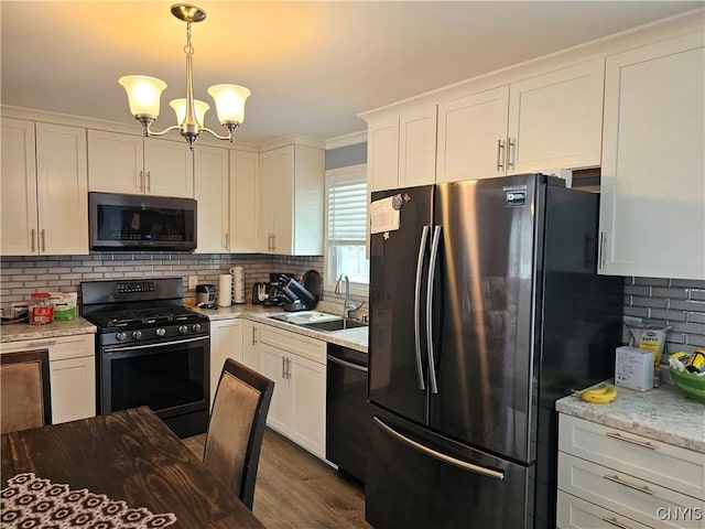 kitchen with decorative backsplash, dishwasher, gas range, freestanding refrigerator, and a sink