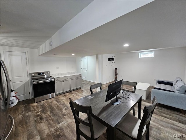 dining area featuring dark wood-type flooring and recessed lighting