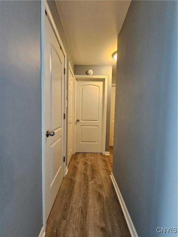 hall with wood finished floors and baseboards