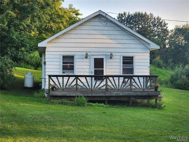 back of property featuring a yard and a deck