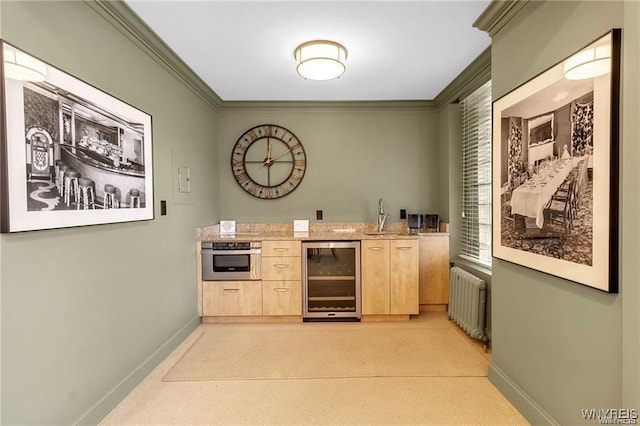 bar featuring wine cooler, crown molding, radiator, stainless steel oven, and a sink