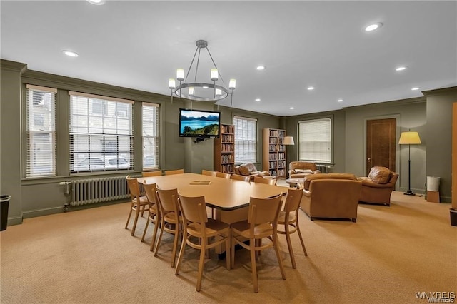 dining space with crown molding, recessed lighting, light colored carpet, and radiator