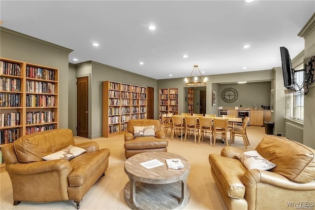 sitting room featuring recessed lighting, ornamental molding, and light colored carpet