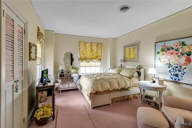 carpeted bedroom featuring visible vents