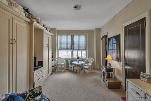 sitting room featuring light carpet and visible vents