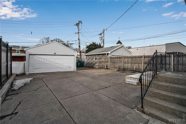 view of patio featuring a garage, fence, and an outdoor structure