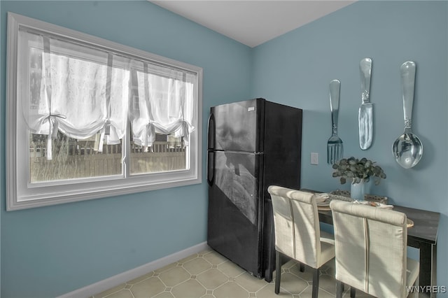 kitchen with freestanding refrigerator and baseboards