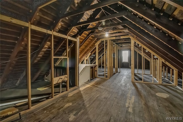 unfinished attic with an upstairs landing