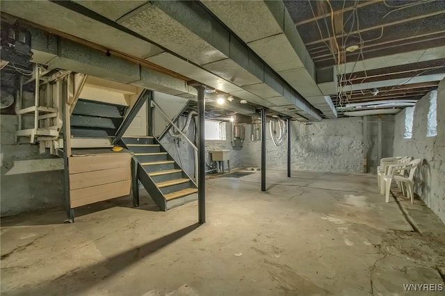 below grade area with stairway and a sink