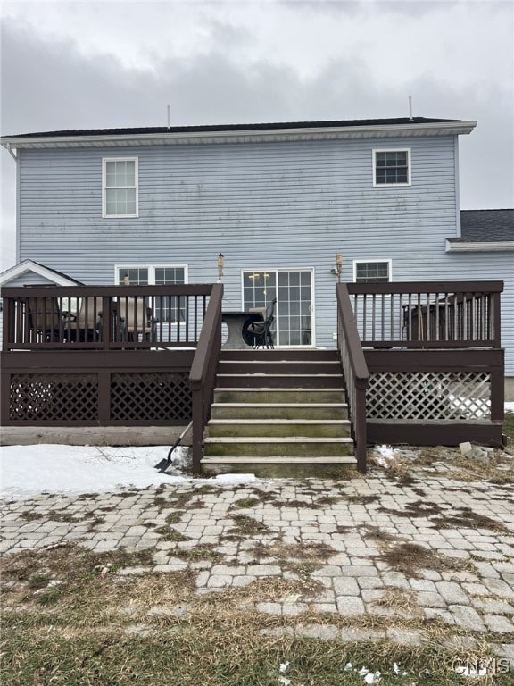 rear view of property featuring a deck