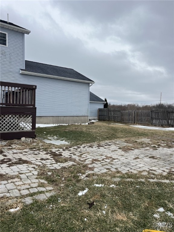 view of yard with fence and a wooden deck