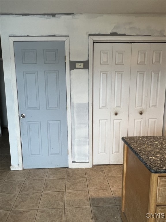 interior space featuring dark tile patterned flooring