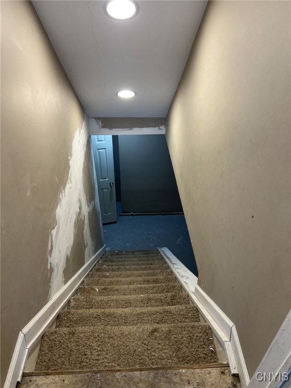 staircase with recessed lighting