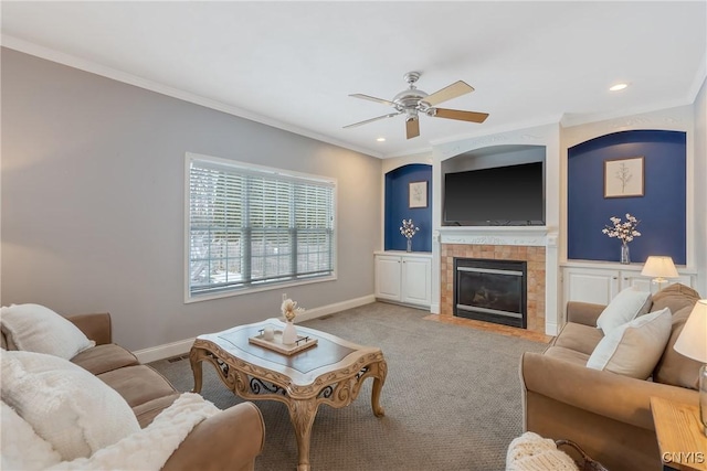 living area with light carpet, baseboards, ornamental molding, and a tiled fireplace