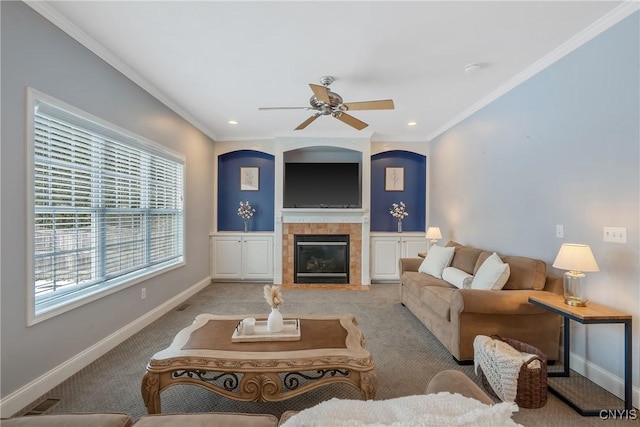 carpeted living room featuring ornamental molding, a tile fireplace, and baseboards