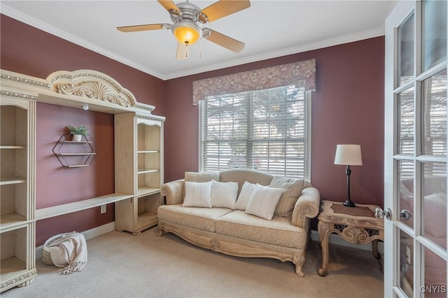 sitting room with ornamental molding, carpet flooring, and a ceiling fan