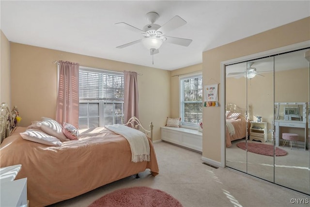 carpeted bedroom featuring a closet, a ceiling fan, and baseboards