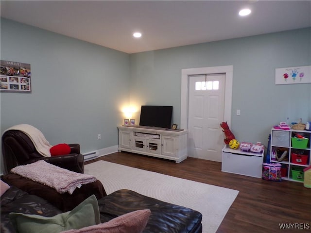 living room with a baseboard heating unit, dark wood-style flooring, and recessed lighting