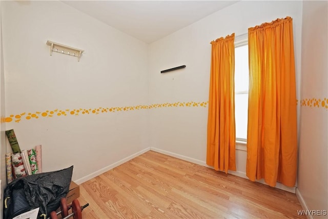 empty room with light wood-style floors and baseboards