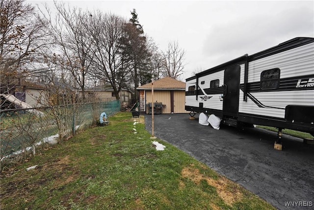 view of yard featuring an outbuilding and fence