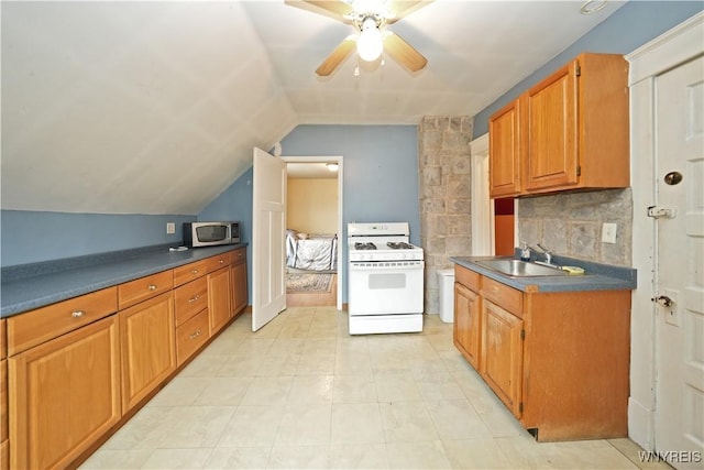 kitchen featuring a sink, backsplash, white gas range, stainless steel microwave, and dark countertops