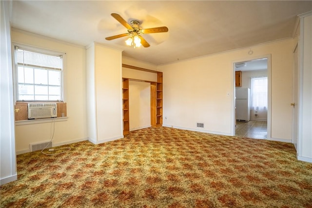 unfurnished bedroom featuring carpet floors, cooling unit, crown molding, and freestanding refrigerator