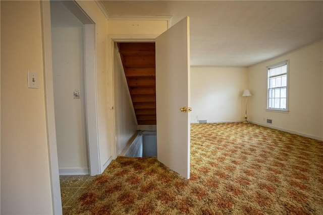 corridor with carpet and baseboards