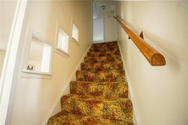 stairway featuring baseboards